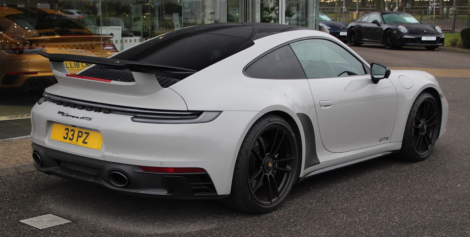 Close-up of satin PPF on a 911 wing, with a thin edge at the shut.